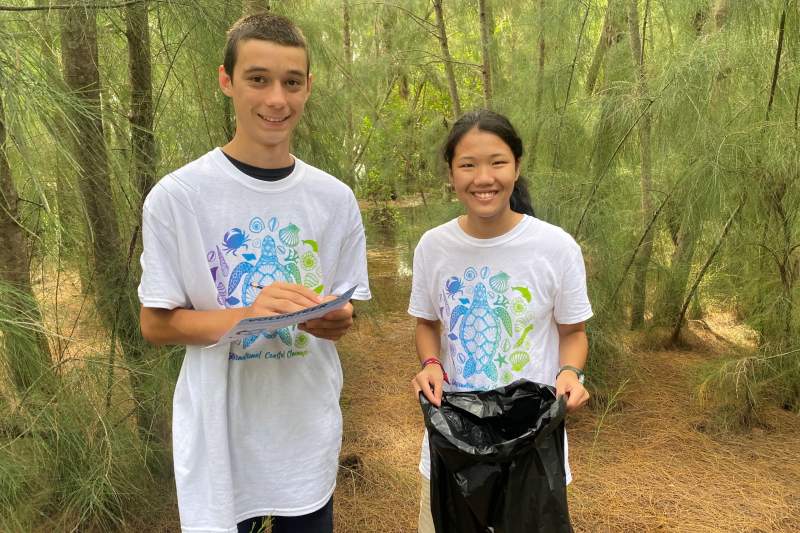 Luke and Lani collect trash on one of the spoil islands