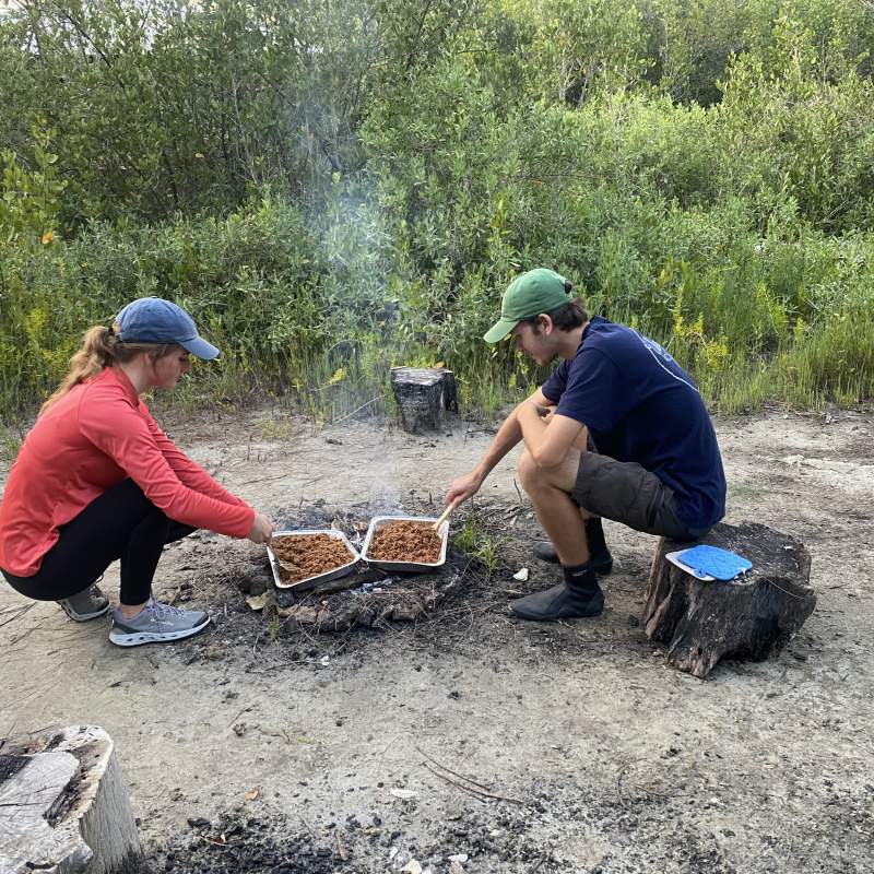 Sarah and Jacob cook taco meat for the team while camping on Boy Scout Island in Vero Beach