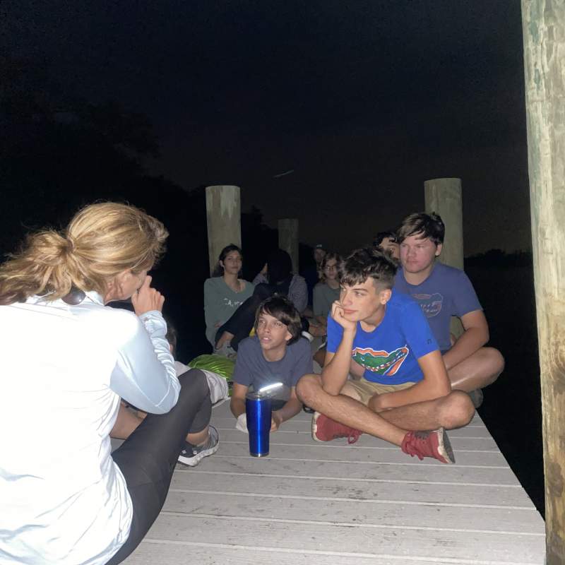 Mrs. Jenn leads a devotion on the dock