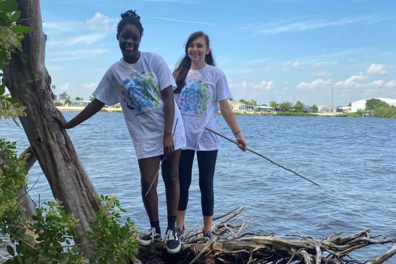 Xana and Sofie look for debris along the shoreline